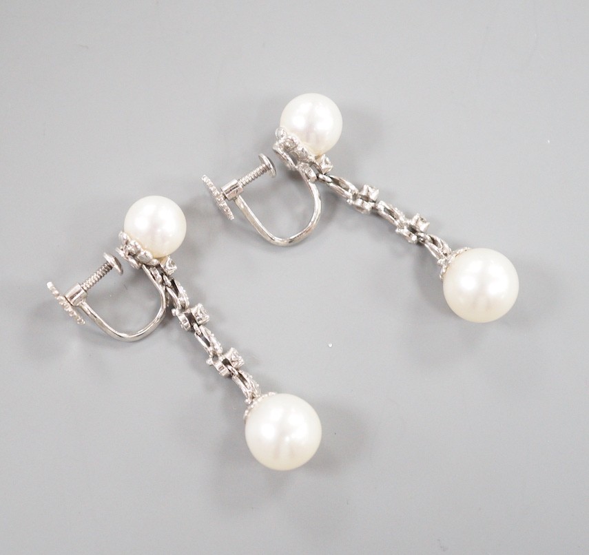 A modern pair of Maxim 14k white metal two stone cultured pearl and six stone diamond chip set line drop ear clips, 38mm, gross weight 6.3 grams.